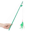 Hand holding a green interactive feather wand cat toy