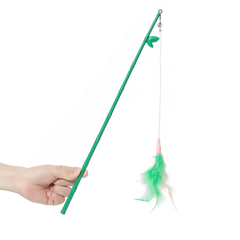 Hand holding a green interactive feather wand cat toy