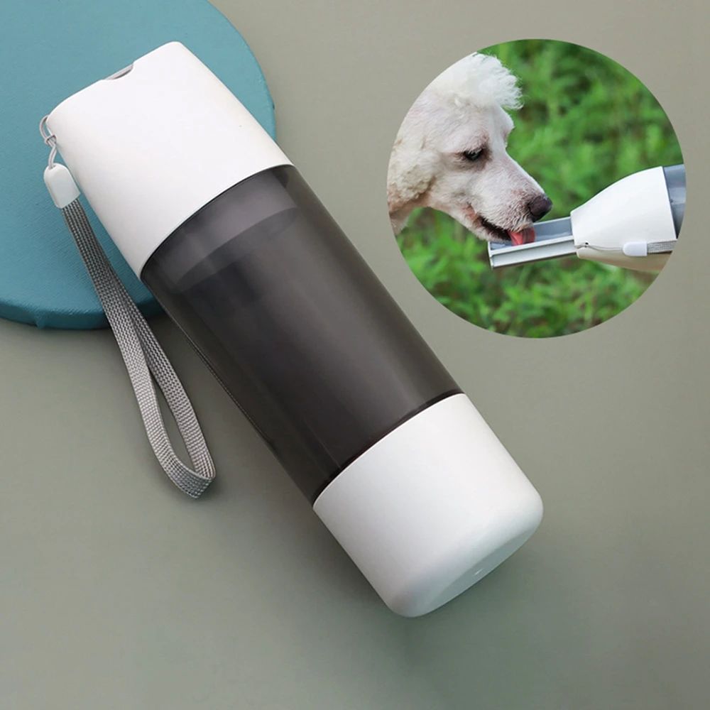 Dog drinking from a white 3-in-1 travel water bottle with black lid