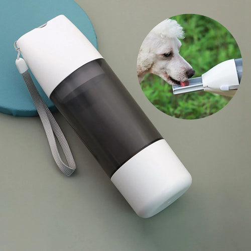 Dog drinking from a white 3-in-1 travel water bottle with black lid